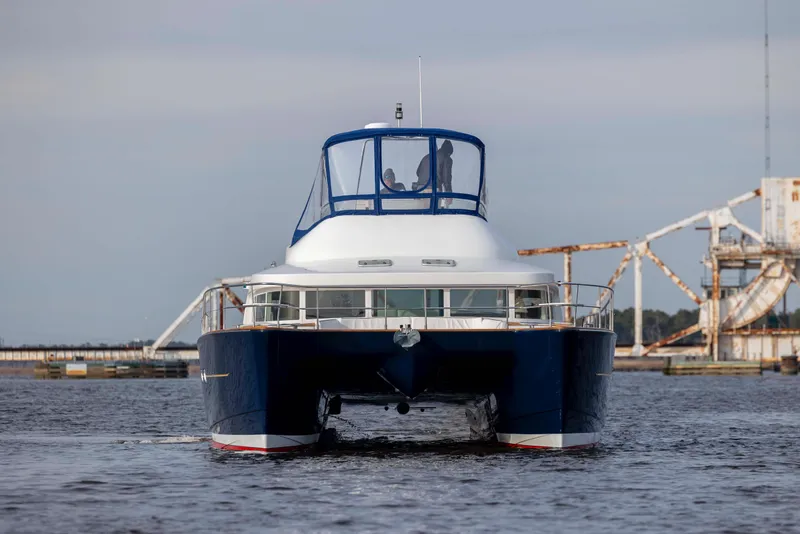 Slide: The Image of Front view of a 2004 Lagoon 43 PC yacht on the water. - 3