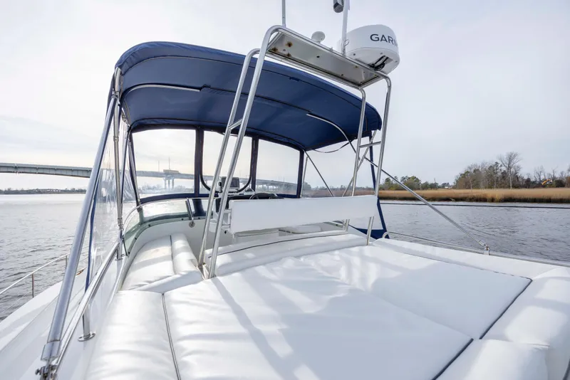 Slide: The Image of 2004 Lagoon 43 PC yacht with blue canopy cruising on a calm river. - 30