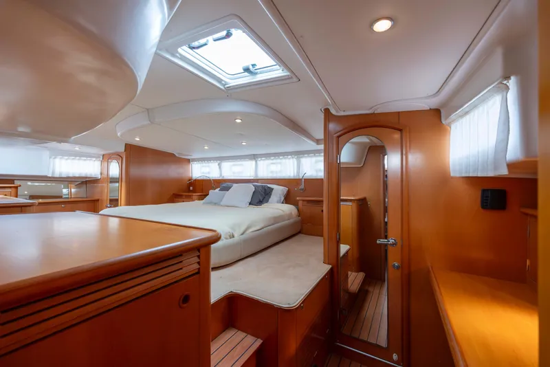 Slide: The Image of Luxurious interior of 2004 Lagoon 43 PC yacht with cozy bedroom and wooden finishes. - 32