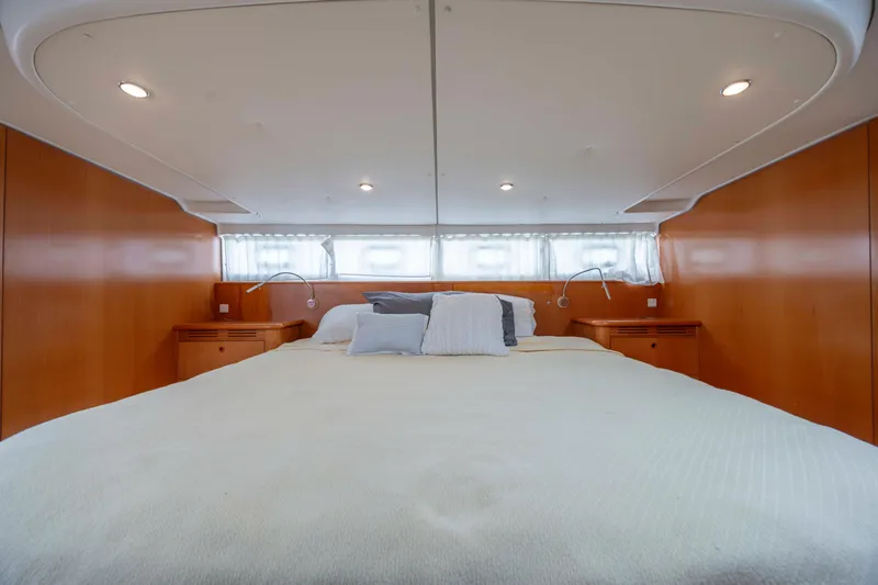 Slide: The Image of Luxurious bedroom interior of 2004 Lagoon 43 PC yacht with cozy bedding and wooden accents. - 35
