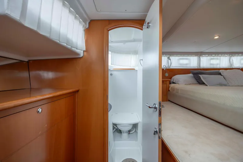 Slide: The Image of Interior of 2004 Lagoon 43 PC yacht featuring bedroom and compact bathroom. - 40