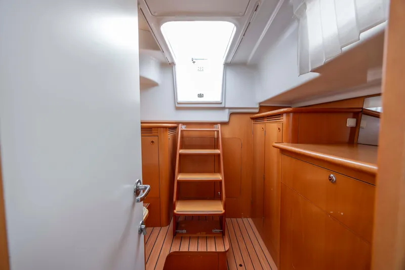 Slide: The Image of Interior of 2004 Lagoon 43 PC yacht with wooden cabinetry and stairs. - 43