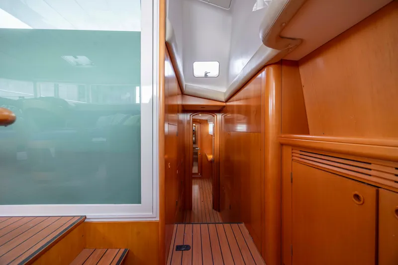 Slide: The Image of Interior view of 2004 Lagoon 43 PC yacht with wooden paneling and sleek design. - 45