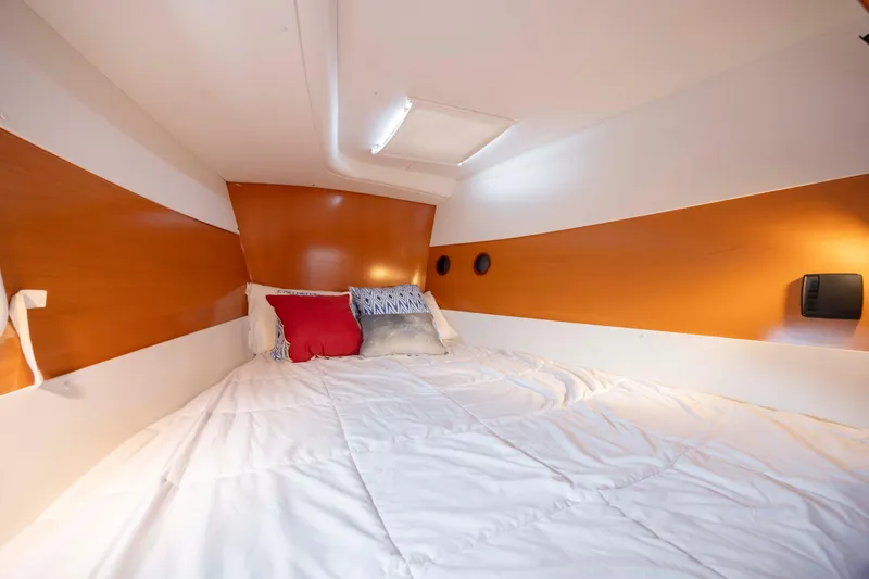 Slide: The Image of Cozy cabin interior of 2004 Lagoon 43 PC yacht with comfortable bedding and warm lighting. - 48