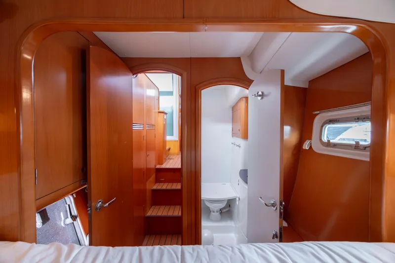 Slide: The Image of Interior of 2004 Lagoon 43 PC yacht with wooden cabinetry and compact bathroom. - 49