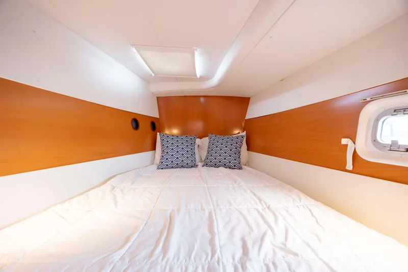 Slide: The Image of Cozy cabin interior of 2004 Lagoon 43 PC yacht with stylish bedding and wood accents. - 55