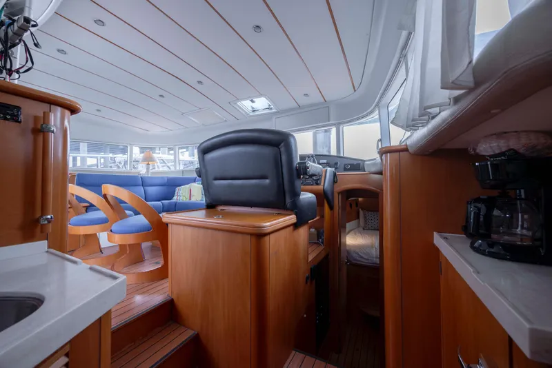 Slide: The Image of Interior of 2004 Lagoon 43 PC yacht with modern seating and wooden finishes. - 63