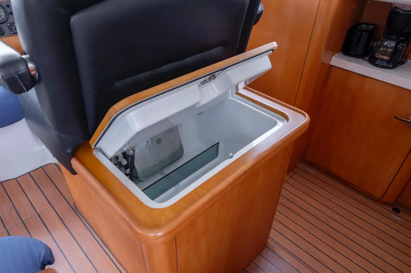 Slide: The Image of Open storage compartment in 2004 Lagoon 43 PC yacht interior with wooden flooring. - 64