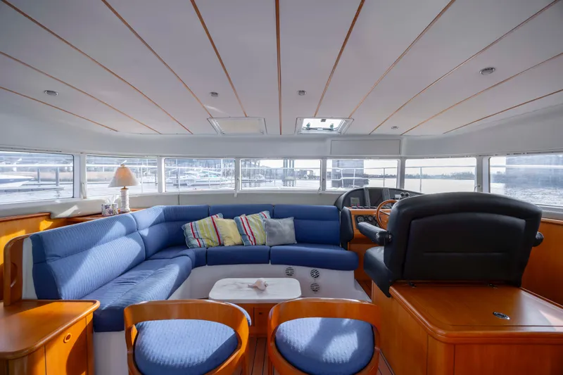 Slide: The Image of Luxurious interior of 2004 Lagoon 43 PC yacht with blue seating and panoramic windows. - 65