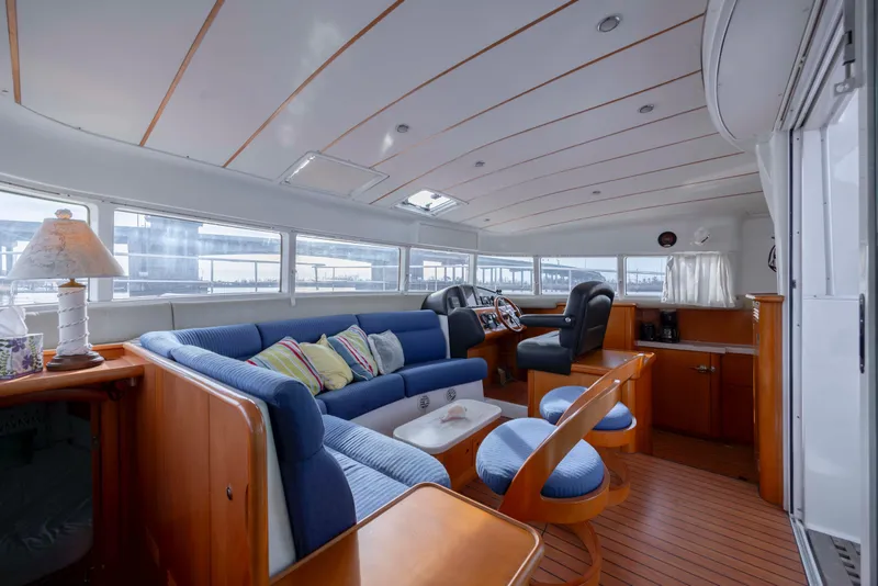 Slide: The Image of Luxurious interior of 2004 Lagoon 43 PC yacht with blue seating and wooden accents. - 66