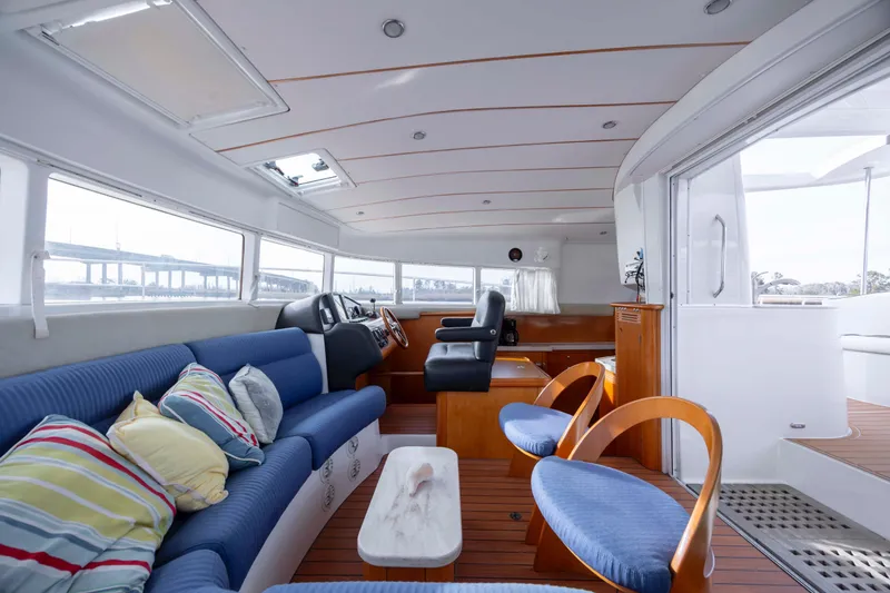Slide: The Image of Interior of 2004 Lagoon 43 PC yacht with blue seating and wooden accents. - 67