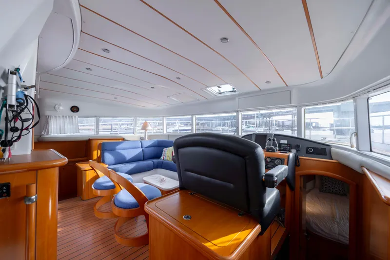 Slide: The Image of Luxurious interior of 2004 Lagoon 43 PC yacht with blue seating and wooden accents. - 68