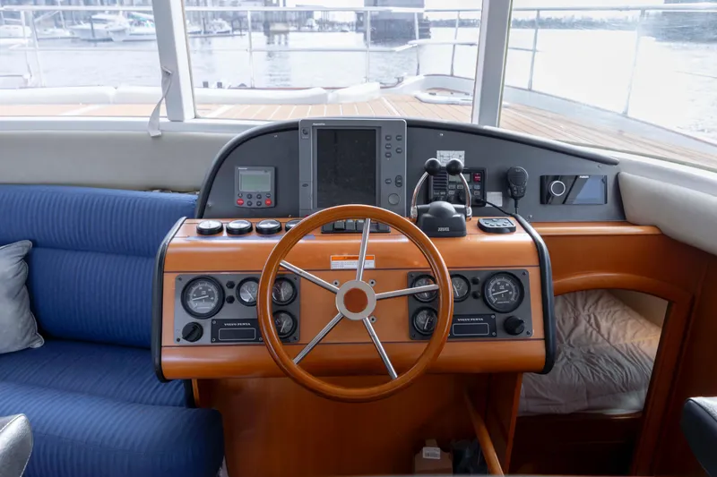 Slide: The Image of Cockpit of 2004 Lagoon 43 PC yacht with steering wheel and navigation instruments. - 69