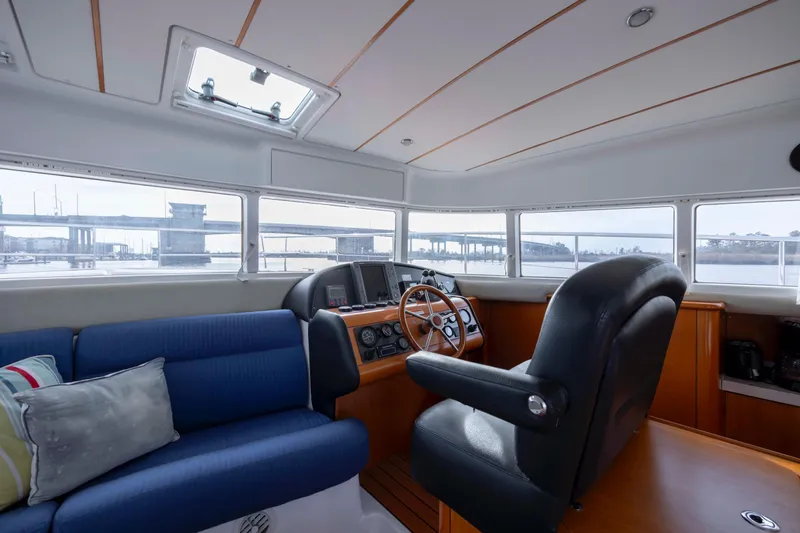 Slide: The Image of Interior of 2004 Lagoon 43 PC yacht with helm, seating, and panoramic windows. - 70
