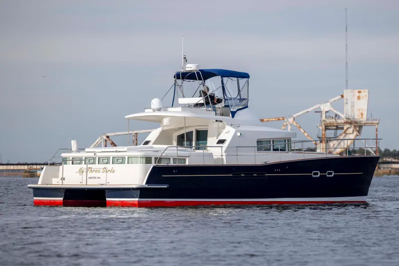 Slide: The Image of 2004 Lagoon 43 PC yacht on water, featuring a sleek design and spacious deck. - 9