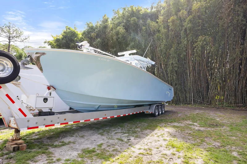 Slide: The Image of 2016 SeaHunter 41 Tournament boat on trailer, surrounded by lush greenery. - 1