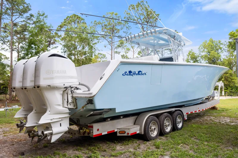 Slide: The Image of 2016 SeaHunter 41 Tournament boat on trailer with Yamaha engines, parked outdoors. - 12