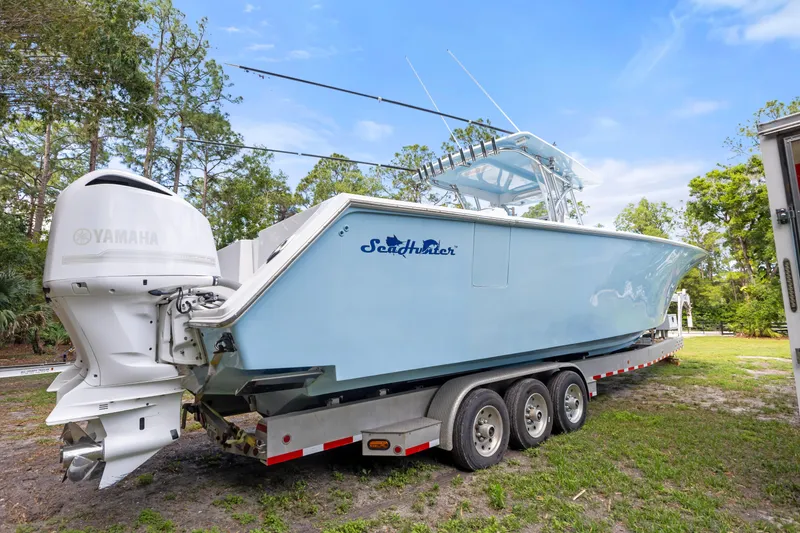 Slide: The Image of 2016 SeaHunter 41 Tournament boat on trailer with Yamaha engines, parked outdoors. - 15