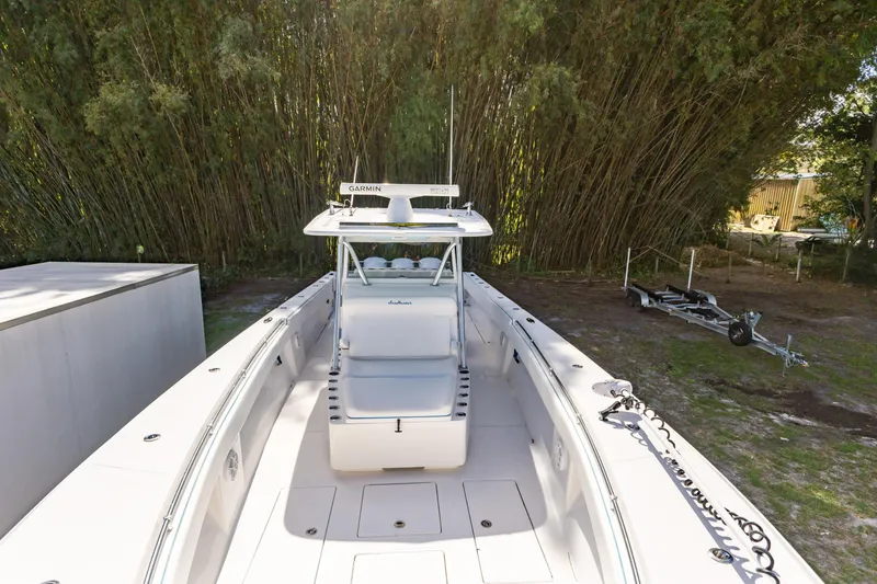 Slide: The Image of 2016 SeaHunter 41 Tournament boat with Garmin equipment, parked near lush greenery. - 21