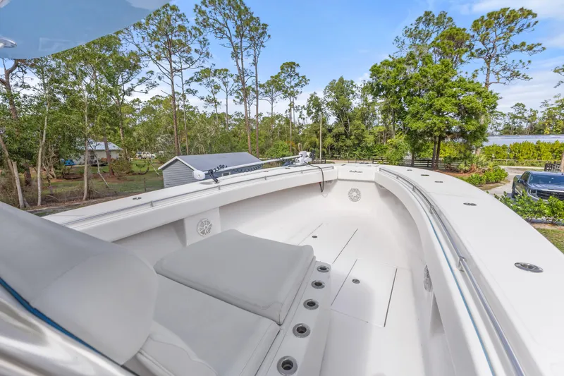 Slide: The Image of 2016 SeaHunter 41 Tournament boat with spacious deck, surrounded by lush greenery. - 25