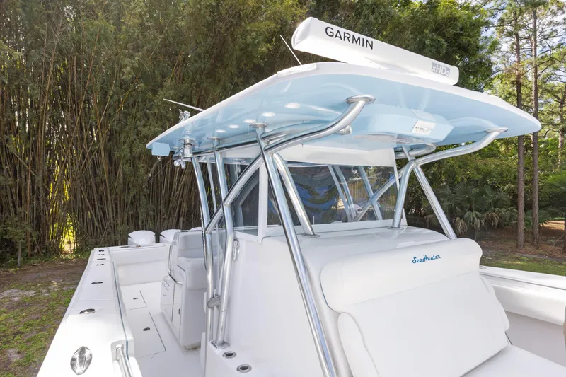 Slide: The Image of 2016 SeaHunter 41 Tournament boat with Garmin radar, surrounded by lush greenery. - 28