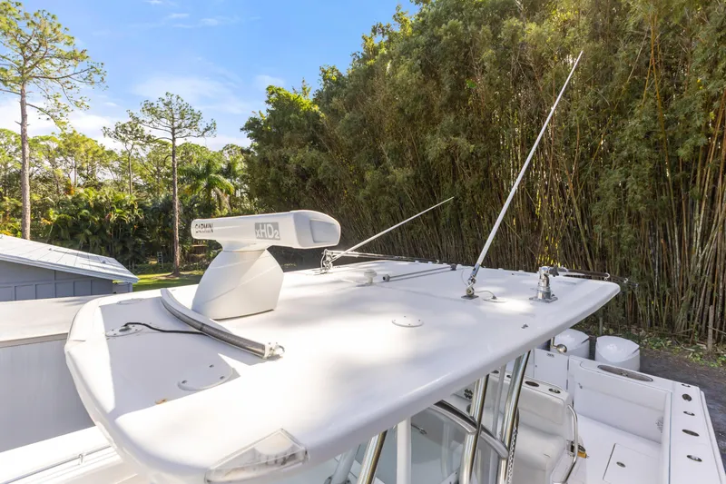 Slide: The Image of 2016 SeaHunter 41 Tournament boat with radar and antennas, surrounded by lush greenery. - 29