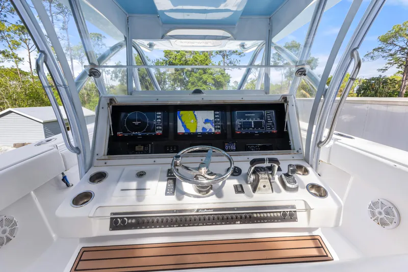 Slide: The Image of 2016 SeaHunter 41 Tournament boat helm with advanced navigation displays and controls. - 31