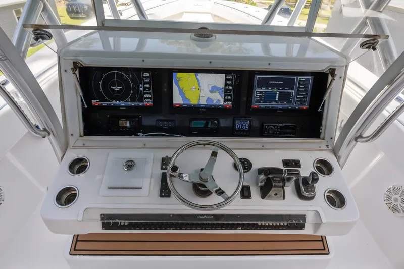 Slide: The Image of 2016 SeaHunter 41 Tournament helm with advanced navigation displays and controls. - 32