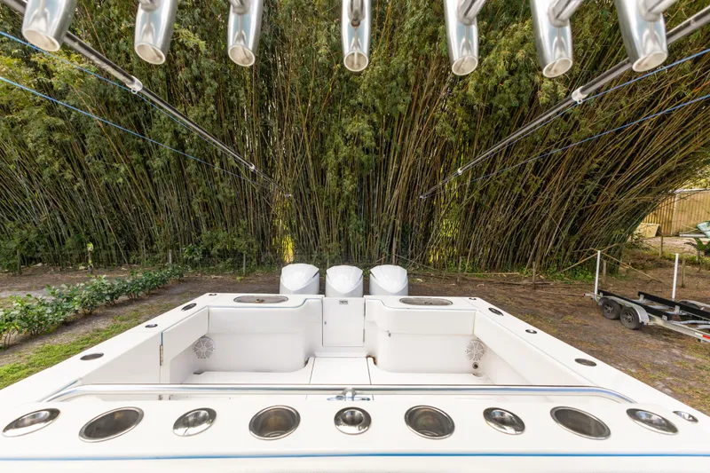 Slide: The Image of 2016 SeaHunter 41 Tournament boat with rod holders, set against lush bamboo backdrop. - 34