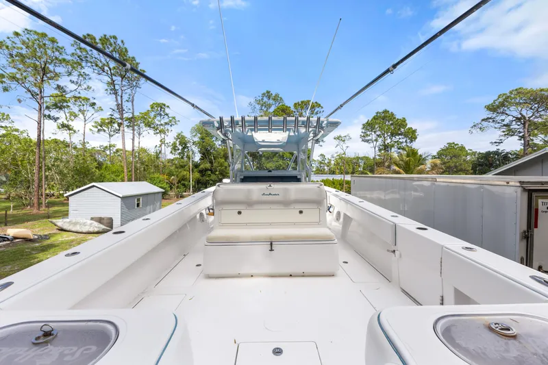Slide: The Image of 2016 SeaHunter 41 Tournament boat deck with seating, surrounded by trees and blue sky. - 36