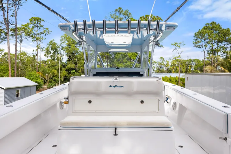 Slide: The Image of 2016 SeaHunter 41 Tournament boat interior with seating and canopy, surrounded by trees. - 39