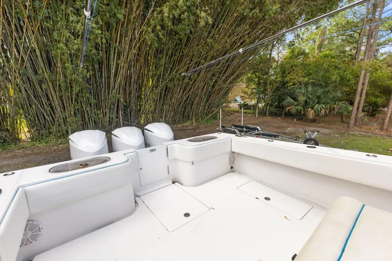 Slide: The Image of 2016 SeaHunter 41 Tournament boat with triple engines, surrounded by lush greenery. - 44