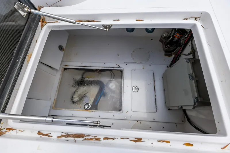 Slide: The Image of 2016 SeaHunter 41 Tournament boat storage compartment with leaves and equipment. - 50