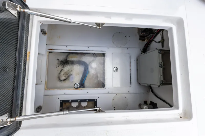 Slide: The Image of 2016 SeaHunter 41 Tournament boat storage compartment with visible wiring and equipment. - 51