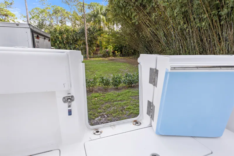 Slide: The Image of 2016 SeaHunter 41 Tournament boat interior with open hatch, lush greenery in background. - 53