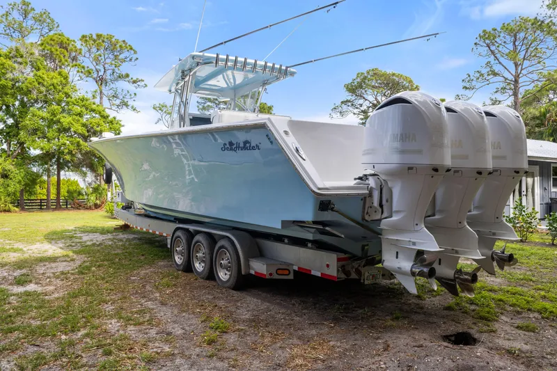 Slide: The Image of 2016 SeaHunter 41 Tournament boat with triple Yamaha engines on a trailer. - 7