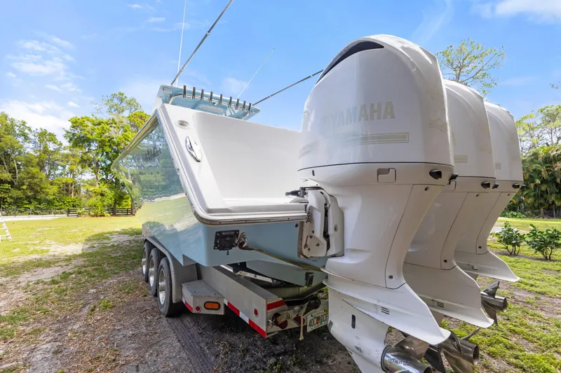 Slide: The Image of 2016 SeaHunter 41 Tournament boat with triple Yamaha outboard engines on a trailer. - 8