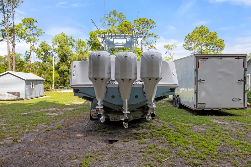 Slide: The Image of 2016 SeaHunter 41 Tournament boat with four powerful outboard engines, parked outdoors. - 9