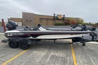 Slide: The Image of 2017 Nitro Z21 boat on trailer, parked in a lot with scenic background. - 1