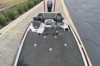 Slide: The Image of 2017 Nitro Z21 boat with spacious deck and seating, parked on paved area. - 6