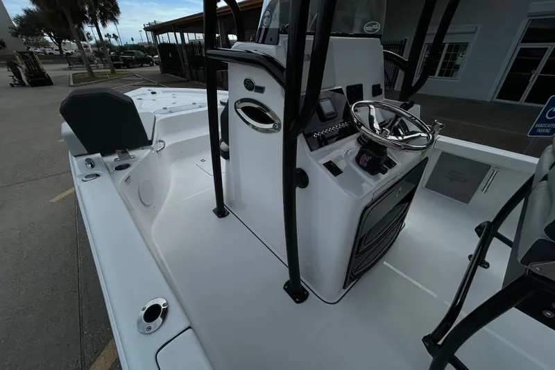 Slide: The Image of 2026 Sea Pro 250 Bay boat interior with steering console and seating area. - 12