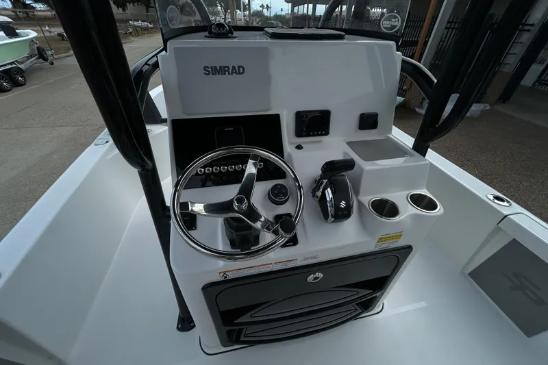 Slide: The Image of 2026 Sea Pro 250 Bay boat console with steering wheel and Simrad electronics. - 13