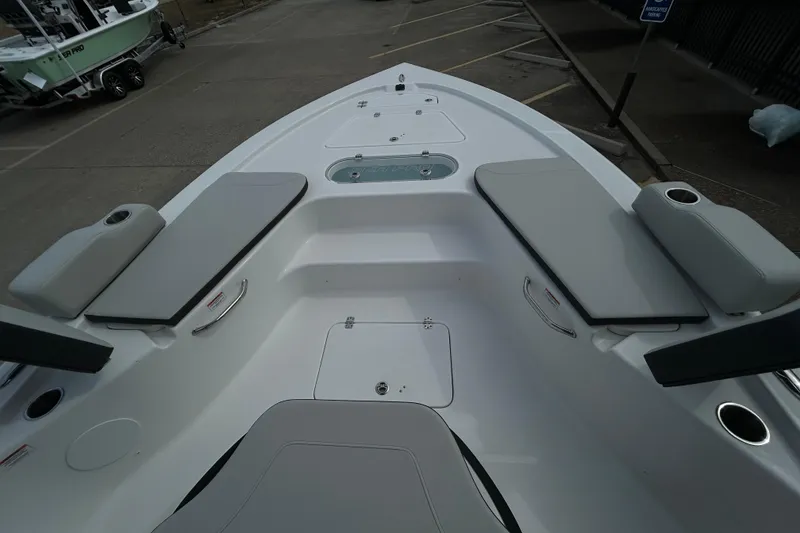 Slide: The Image of 2026 Sea Pro 250 Bay boat interior with cushioned seating and storage compartments. - 19