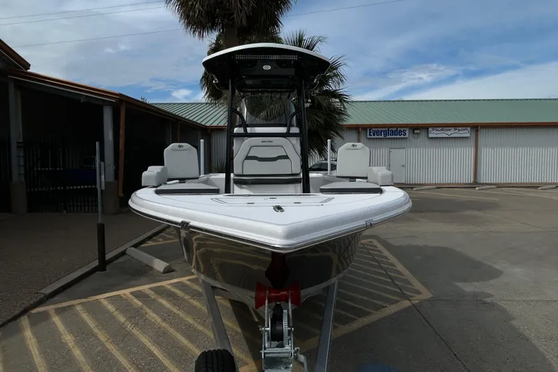 Slide: The Image of 2026 Sea Pro 250 Bay boat on trailer, parked outdoors near a building. - 4