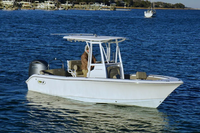 The Image of 2026 Sea Hunt Ultra 219 boat on calm blue water, featuring sleek design and modern amenities. - 0