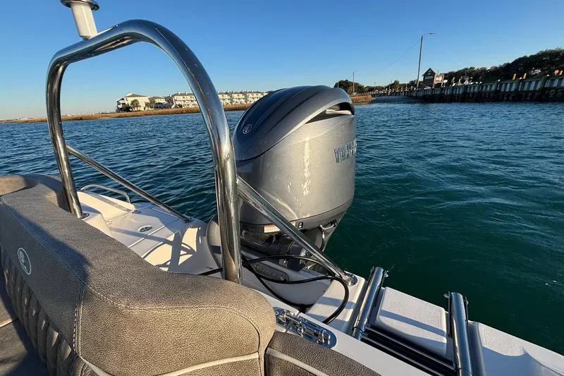 Slide: The Image of 2026 Sea Hunt Ultra 219 boat with Yamaha outboard motor on calm water. - 16