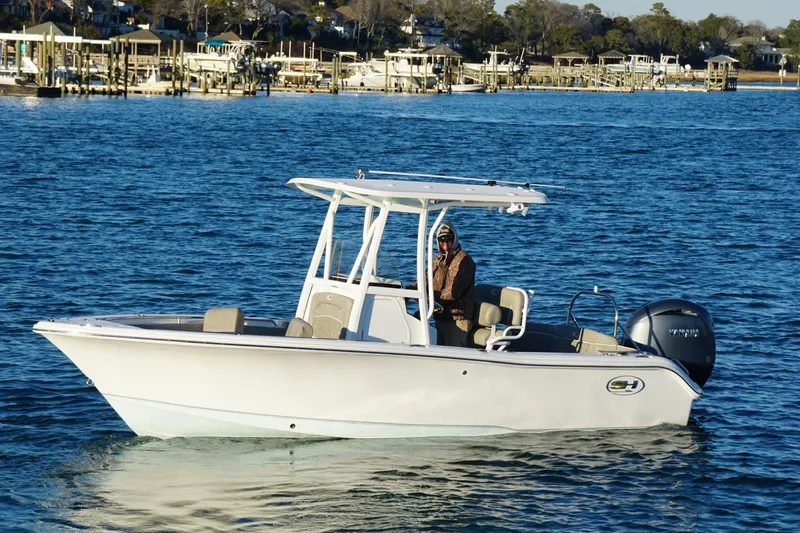 Slide: The Image of 2026 Sea Hunt Ultra 219 boat on calm water, featuring a sleek design and modern amenities. - 17