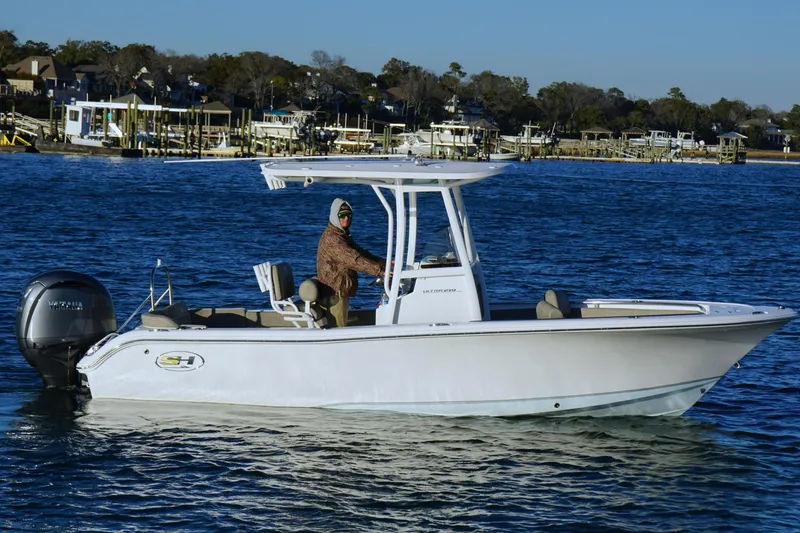 Slide: The Image of 2026 Sea Hunt Ultra 219 boat cruising on a calm blue lake. - 19
