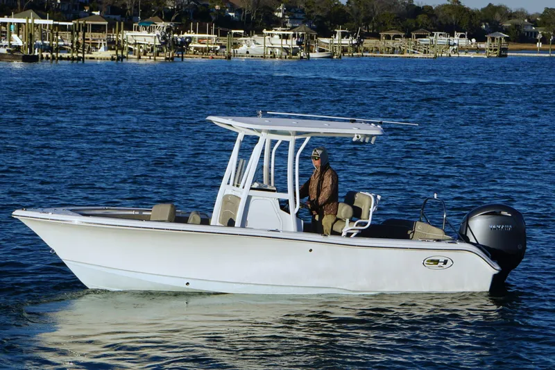 Slide: The Image of 2026 Sea Hunt Ultra 219 boat on water, featuring sleek design and powerful engine. - 2