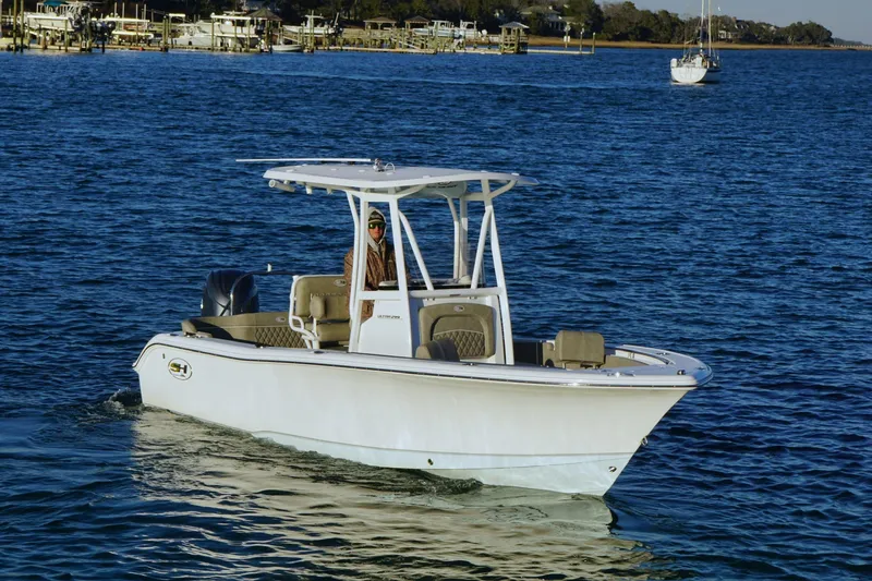Slide: The Image of 2026 Sea Hunt Ultra 219 boat cruising on calm blue waters. - 4